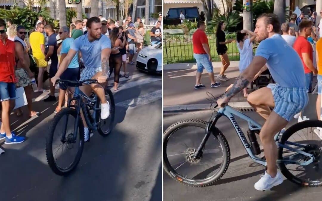 Conor McGregor steals attention away from Bugatti as he cycles past it